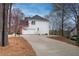 Rear exterior showing a white two-story home with a long concrete driveway at 3534 Brandywine Nw Rd, Kennesaw, GA 30144
