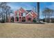 Inviting two-story brick home with manicured lawn and covered front porch at 3534 Brandywine Nw Rd, Kennesaw, GA 30144