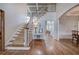 Open foyer with hardwood floors, staircase, and views of the kitchen at 3534 Brandywine Nw Rd, Kennesaw, GA 30144