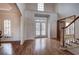 Spacious foyer featuring hardwood floors, a staircase, and multiple doorways, providing access to various areas of the home at 3534 Brandywine Nw Rd, Kennesaw, GA 30144