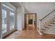 Inviting foyer with hardwood floors, staircase, and double glass doors, offering a bright and spacious entrance to the home at 3534 Brandywine Nw Rd, Kennesaw, GA 30144