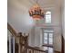 Grand foyer showcasing a decorative chandelier, high ceilings, and an arched window, creating an elegant and open space at 3534 Brandywine Nw Rd, Kennesaw, GA 30144