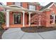 Charming front porch with brick flooring, white columns, and seating area at 3534 Brandywine Nw Rd, Kennesaw, GA 30144