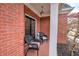 Cozy front porch with brick detail and wicker furniture at 3534 Brandywine Nw Rd, Kennesaw, GA 30144
