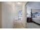 Hallway view into a bedroom featuring a four-poster bed with a wooden dresser at 3534 Brandywine Nw Rd, Kennesaw, GA 30144