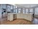 Spacious kitchen open to living space with a long quartz island, modern appliances, and hardwood floors at 3534 Brandywine Nw Rd, Kennesaw, GA 30144