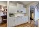Modern kitchen with white cabinets, tile backsplash, stainless appliances, and hardwood flooring at 3534 Brandywine Nw Rd, Kennesaw, GA 30144