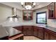 Well-lit basement kitchenette with stainless steel hood, dark wood cabinets, and natural light at 3534 Brandywine Nw Rd, Kennesaw, GA 30144