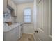 Well-lit laundry room with tile floor and white washer and dryer set at 3534 Brandywine Nw Rd, Kennesaw, GA 30144