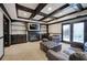 Finished basement featuring a fireplace, built-in shelving, dark trim, and a leather sofa and ottoman at 3534 Brandywine Nw Rd, Kennesaw, GA 30144