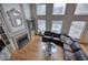 Open concept living room featuring a fireplace, built-in shelves, and large windows with a backyard view at 3534 Brandywine Nw Rd, Kennesaw, GA 30144