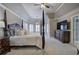 Spacious main bedroom featuring a four-poster bed, large windows, and an elegant chandelier at 3534 Brandywine Nw Rd, Kennesaw, GA 30144