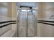 Bathroom with glass-enclosed shower, white subway tile with black trim and a bathtub at 3534 Brandywine Nw Rd, Kennesaw, GA 30144