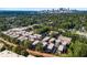 Aerial view of new townhomes in a green neighborhood with city skyline in the distance at 383 Pratt Se Dr # 503, Atlanta, GA 30315