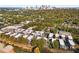 An aerial view of modern townhomes surrounded by mature trees, and a glimpse of the city skyline in the distance at 383 Pratt Se Dr # 503, Atlanta, GA 30315