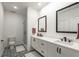 Double vanity bathroom with black fixtures, decorative tile floor and tiled walk-in shower at 383 Pratt Se Dr # 503, Atlanta, GA 30315