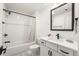 Bathroom featuring walk-in shower with decorative curtain, sink, vanity and black fixtures at 383 Pratt Se Dr # 503, Atlanta, GA 30315