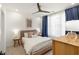 Bright bedroom features a neutral color scheme with blue curtains and a ceiling fan at 383 Pratt Se Dr # 503, Atlanta, GA 30315