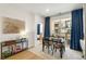 Bright dining area with balcony access and modern decor, next to an open doorway to a bedroom at 383 Pratt Se Dr # 503, Atlanta, GA 30315
