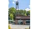 Coffee shop exterior with modern design, featuring a tower and outdoor seating under blue umbrellas at 383 Pratt Se Dr # 503, Atlanta, GA 30315