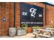 Close-up exterior shot of a brick building with a large sign, barrels, and picnic tables at 383 Pratt Se Dr # 503, Atlanta, GA 30315