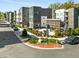 Charming exterior view of modern townhomes, featuring outdoor seating, lush landscaping, and street parking at 383 Pratt Se Dr # 503, Atlanta, GA 30315