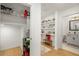 Hallway with wooden floors, open shelves with art and decor, plus view of closet with shelving, and half bath at 383 Pratt Se Dr # 503, Atlanta, GA 30315