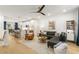 Bright open concept living area with modern decor and hardwood floors flowing into the kitchen at 383 Pratt Se Dr # 503, Atlanta, GA 30315