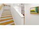 View of staircase with wood and white features, and artwork in the hallway at 383 Pratt Se Dr # 503, Atlanta, GA 30315