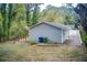 View of the back of the house, which has a concrete driveway and grassy backyard at 1351 Eason Nw St, Atlanta, GA 30314
