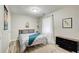 Bedroom with neutral walls, wood look flooring, and a decorative blanket on the bed at 1351 Eason Nw St, Atlanta, GA 30314