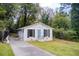 Pleasant single-story home featuring a blue door, classic black shutters, and a simple landscape at 1351 Eason Nw St, Atlanta, GA 30314