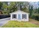 Well-kept white brick house with a lovely front lawn surrounded by mature trees at 1351 Eason Nw St, Atlanta, GA 30314