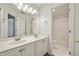 Bright bathroom featuring double sinks, large mirror, vanity with cabinet storage and tiled floors at 1462 Valley Glen Way, Dunwoody, GA 30338