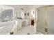 Bathroom featuring a jacuzzi tub, shower, and vanity area at 1462 Valley Glen Way, Dunwoody, GA 30338