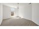 Empty bedroom with window, neutral carpet, and chandelier at 1462 Valley Glen Way, Dunwoody, GA 30338