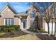 Charming brick home featuring a well-manicured lawn, elegant entryway, and classic architectural details at 1462 Valley Glen Way, Dunwoody, GA 30338