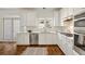 Modern kitchen with stainless steel appliances, white cabinets, and hardwood floors at 1462 Valley Glen Way, Dunwoody, GA 30338