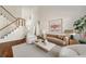Cozy living room featuring a staircase, plush seating, hardwood floors, and natural light at 1462 Valley Glen Way, Dunwoody, GA 30338