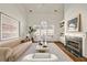 Bright living room with fireplace, hardwood floors, and large windows with seating area at 1462 Valley Glen Way, Dunwoody, GA 30338