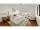 Sun-filled main bedroom with a tray ceiling, plush seating and hardwood floors at 1462 Valley Glen Way, Dunwoody, GA 30338