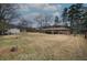 Spacious backyard featuring mature trees, storage shed, and partially fenced in perimeter at 224 E Felton Rd, Cartersville, GA 30121