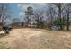 Spacious backyard featuring mature trees, storage shed, and partially fenced in perimeter at 224 E Felton Rd, Cartersville, GA 30121