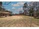 Spacious backyard featuring mature trees, storage shed, and partially fenced in perimeter at 224 E Felton Rd, Cartersville, GA 30121