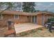 Backyard view of small wooden deck, mature trees, and an outdoor grill at 224 E Felton Rd, Cartersville, GA 30121