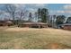 Spacious backyard featuring mature trees, storage shed, and partially fenced in perimeter at 224 E Felton Rd, Cartersville, GA 30121