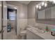 Well lit bathroom features tiled walls and floors, a standard toilet, and vanity at 224 E Felton Rd, Cartersville, GA 30121