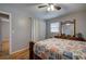 Cozy bedroom features a ceiling fan, wood floors, and a traditional-style dresser with a large mirror at 224 E Felton Rd, Cartersville, GA 30121