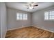 Bright bedroom features a ceiling fan, hardwood floors, and plantation shutters at 224 E Felton Rd, Cartersville, GA 30121