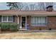 Close up of entryway to a beautiful brick home with shutters and landscaped shrubbery at 224 E Felton Rd, Cartersville, GA 30121